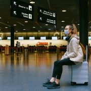 Woman sitting on luggage flexible furlough Embrace HR